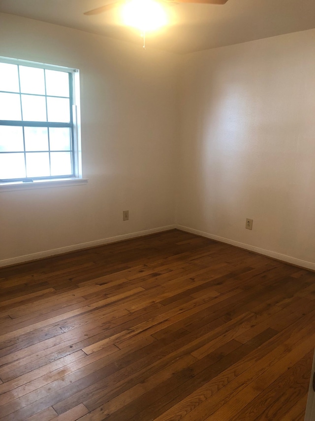 empty room featuring ceiling fan and dark hardwood / wood-style floors