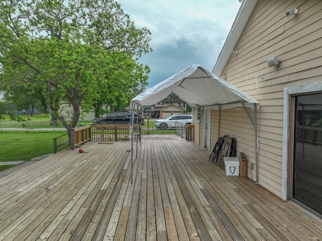 wooden deck featuring a yard