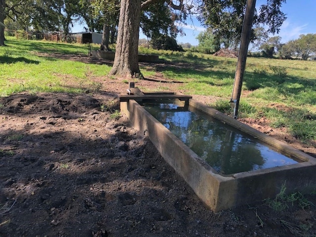 view of storm shelter featuring a yard