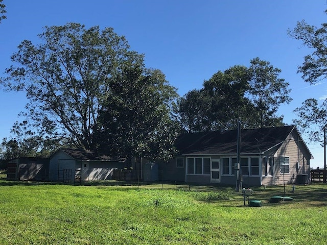 back of house with a lawn