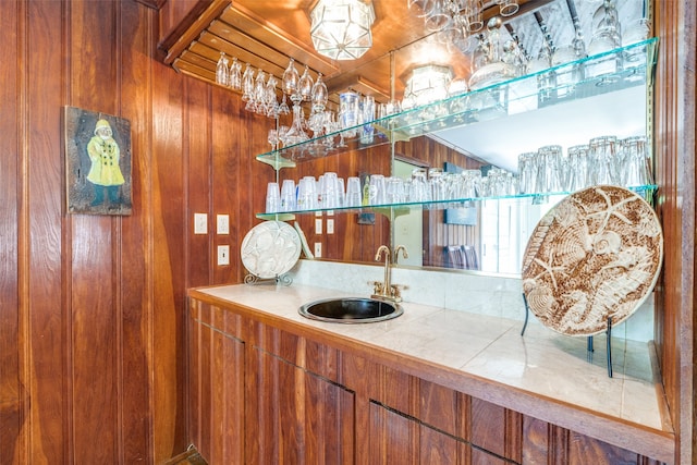 bathroom featuring wood walls and vanity