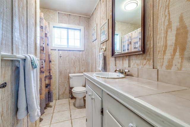 bathroom with tile patterned flooring, vanity, and toilet