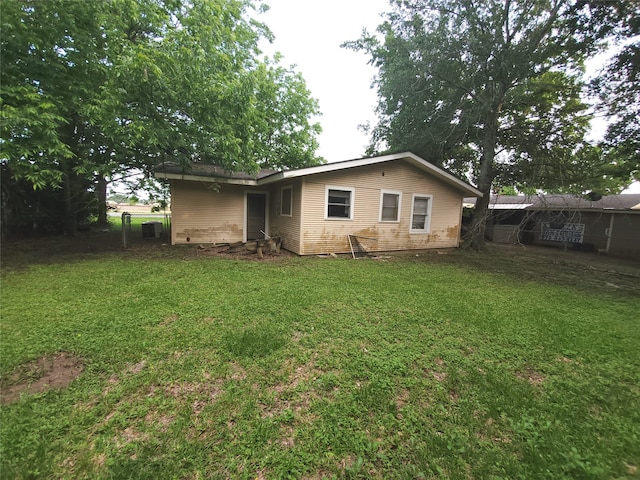 back of property featuring a yard