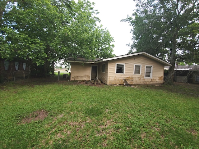 rear view of house with a yard