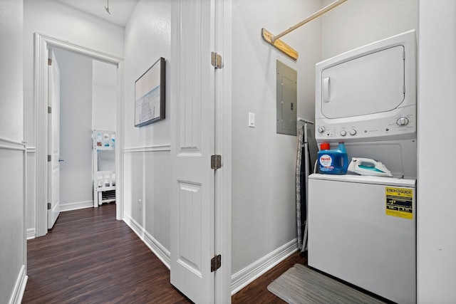 washroom with dark hardwood / wood-style flooring and stacked washer / drying machine