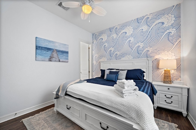 bedroom with dark hardwood / wood-style flooring and ceiling fan