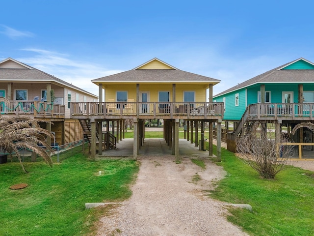 back of property with a yard and a wooden deck