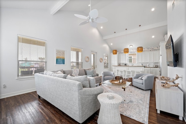 living room featuring ceiling fan, a wealth of natural light, and dark wood-type flooring