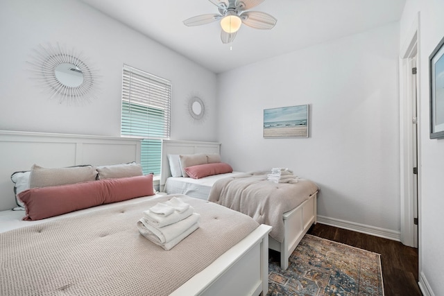 bedroom with dark hardwood / wood-style floors and ceiling fan