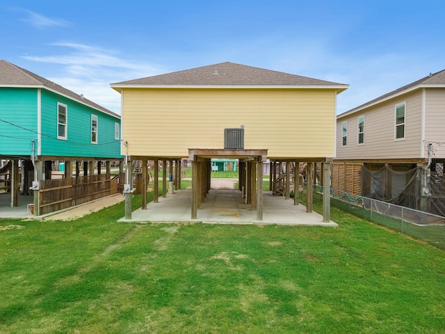 rear view of house featuring a lawn and a patio