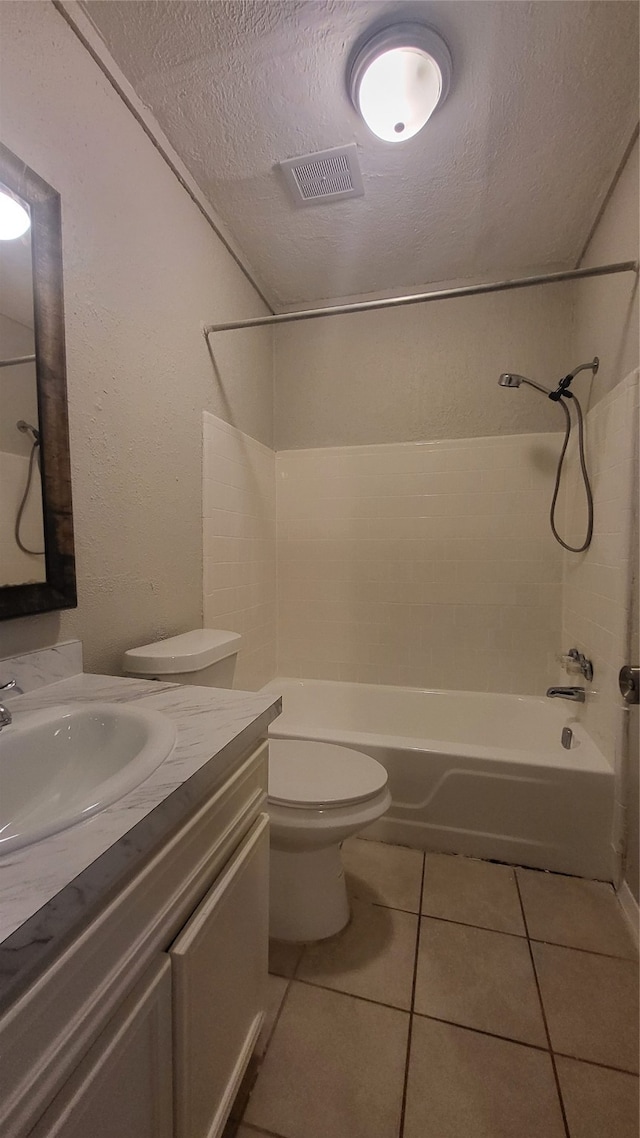 full bathroom with vanity, tile floors, a textured ceiling, toilet, and shower / bath combination