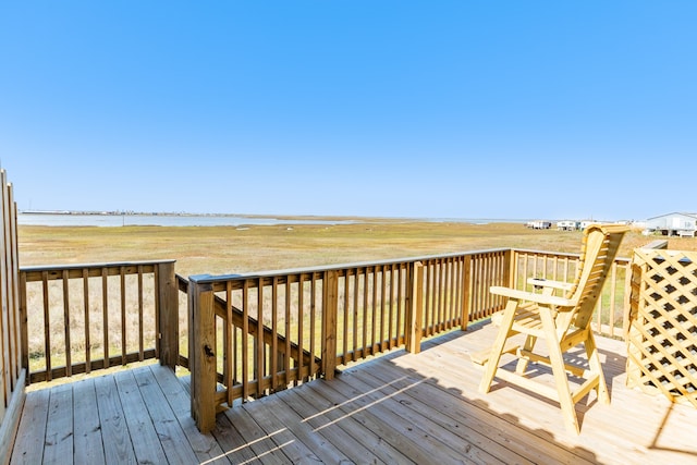 wooden terrace featuring a water view