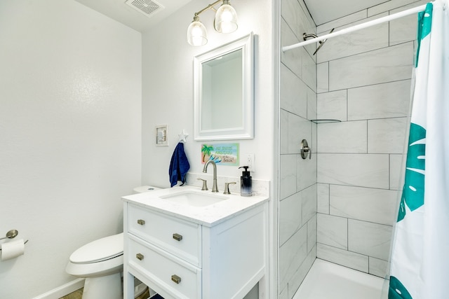 bathroom featuring toilet, large vanity, and walk in shower