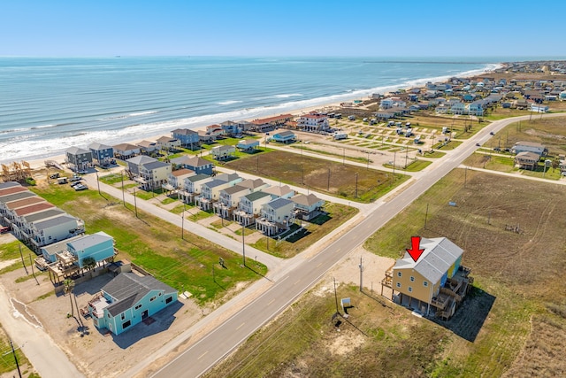 drone / aerial view with a water view and a beach view