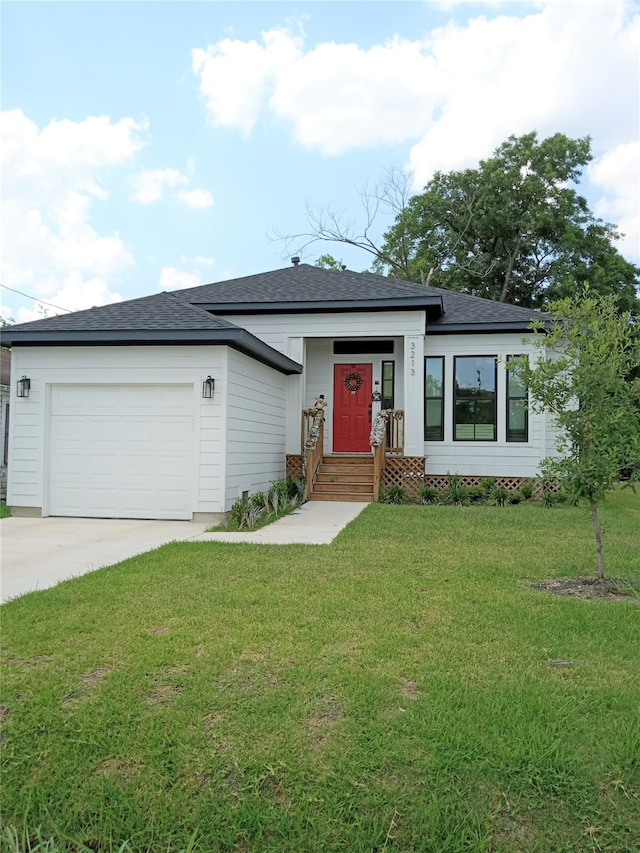 view of front of house with a front lawn and a garage