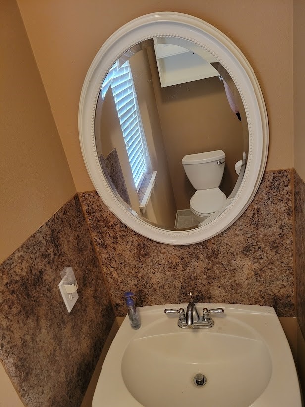 bathroom featuring sink and toilet