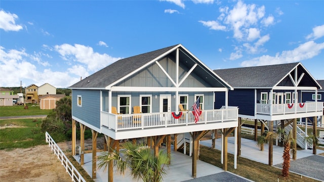 rear view of property featuring a storage shed and a wooden deck