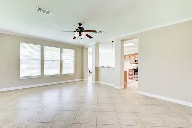 interior space featuring ornamental molding, ceiling fan, and light tile floors