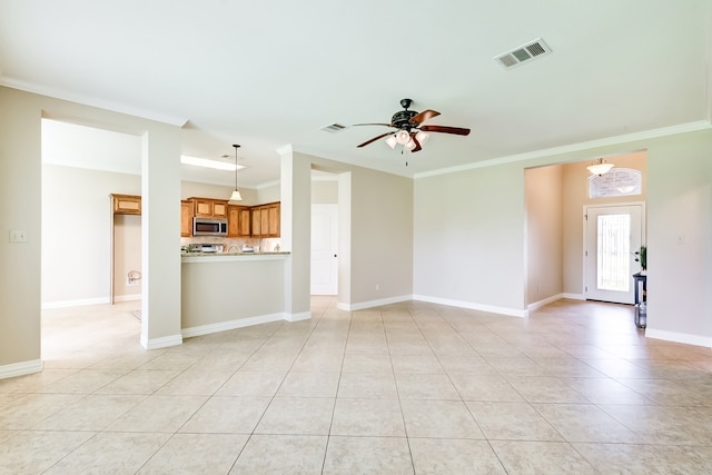 unfurnished living room with ceiling fan, crown molding, and light tile floors