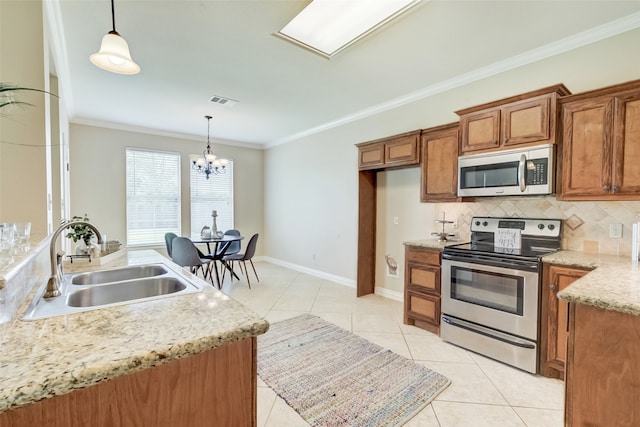 kitchen with ornamental molding, stainless steel appliances, decorative light fixtures, backsplash, and sink