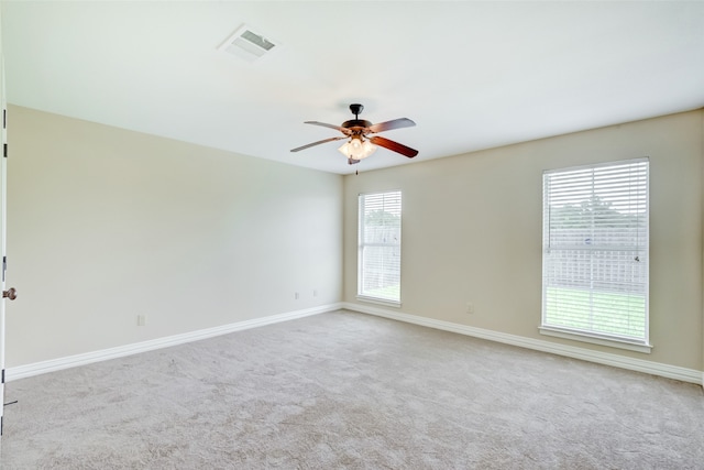 carpeted spare room with ceiling fan