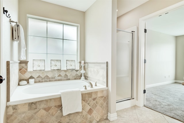 bathroom with tile floors and independent shower and bath