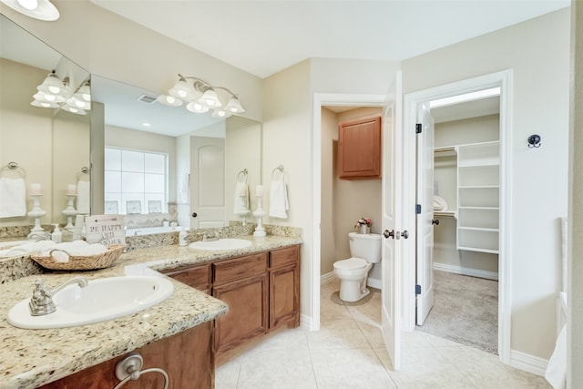 bathroom with tile floors, dual bowl vanity, and toilet