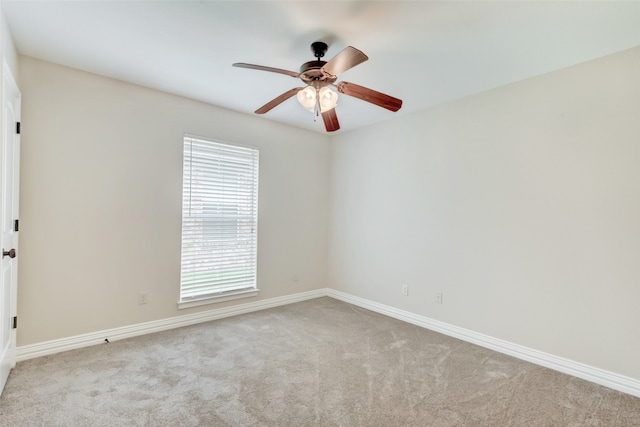 spare room featuring carpet and ceiling fan