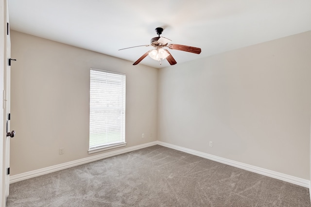 carpeted spare room with ceiling fan