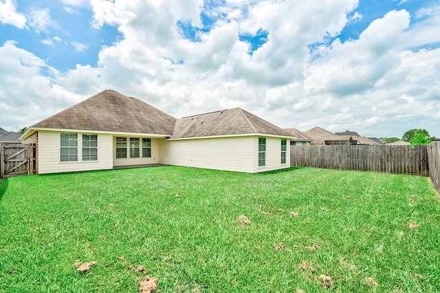 back of house with a yard