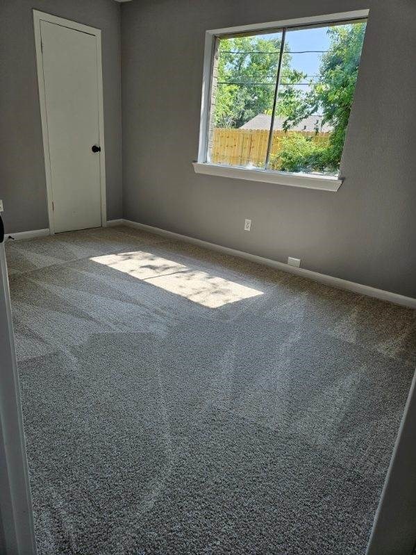 empty room with baseboards and carpet floors