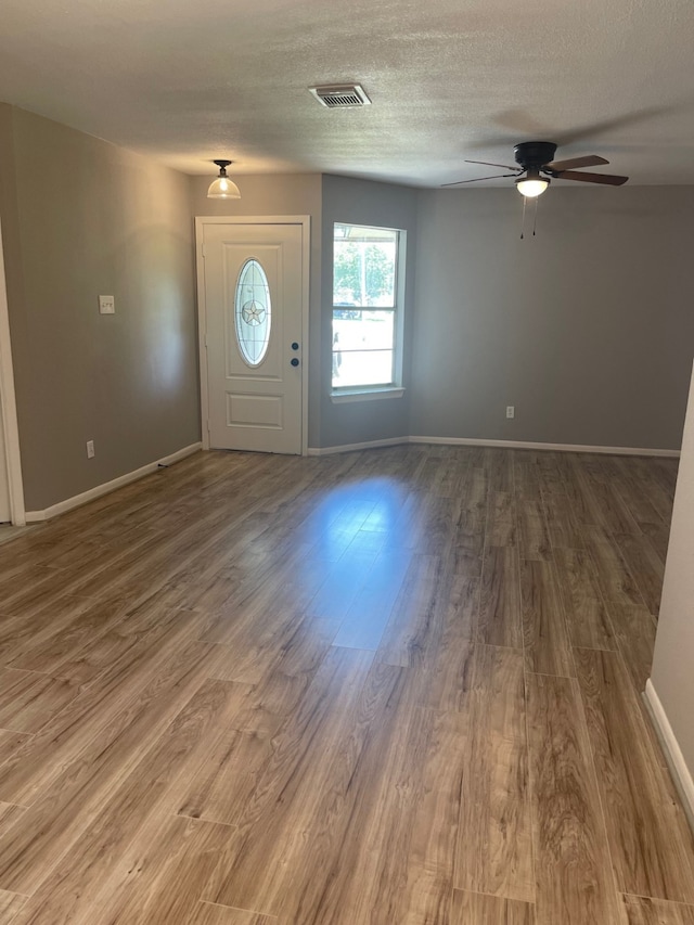 foyer featuring ceiling fan, a textured ceiling, and hardwood / wood-style floors