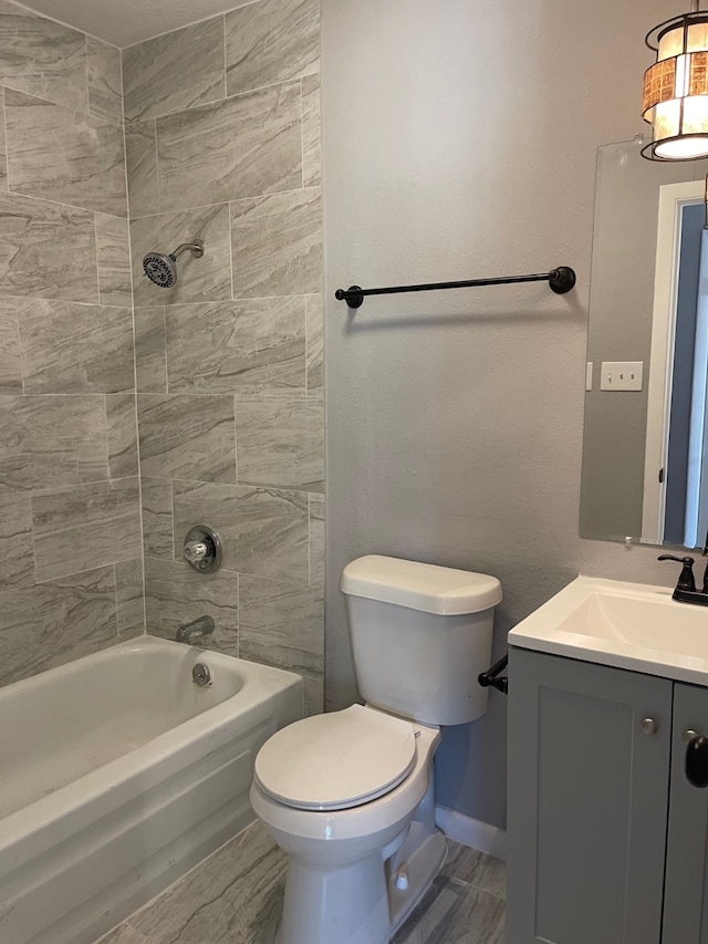 full bathroom featuring tiled shower / bath combo, tile patterned floors, toilet, and vanity