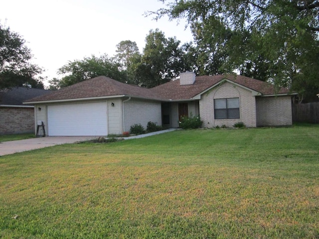 single story home featuring a garage and a front lawn