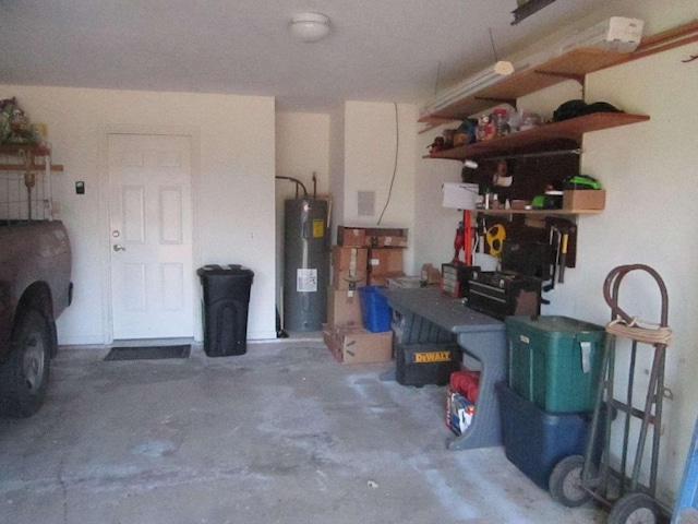 garage with a workshop area and electric water heater