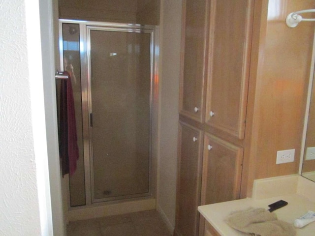 bathroom with vanity and a shower with shower door