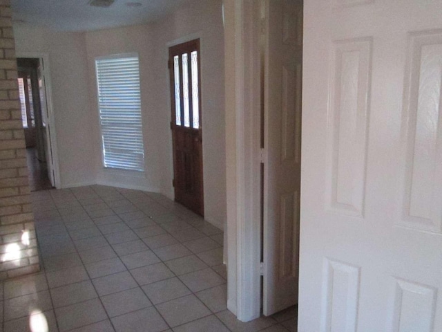 hall featuring light tile patterned floors