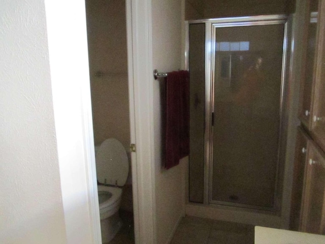 bathroom with walk in shower and toilet