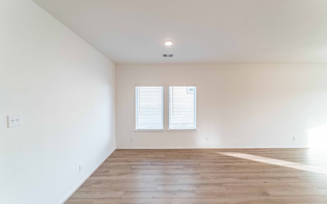 unfurnished room with light hardwood / wood-style flooring