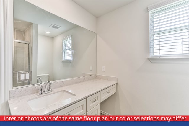 bathroom with large vanity and toilet