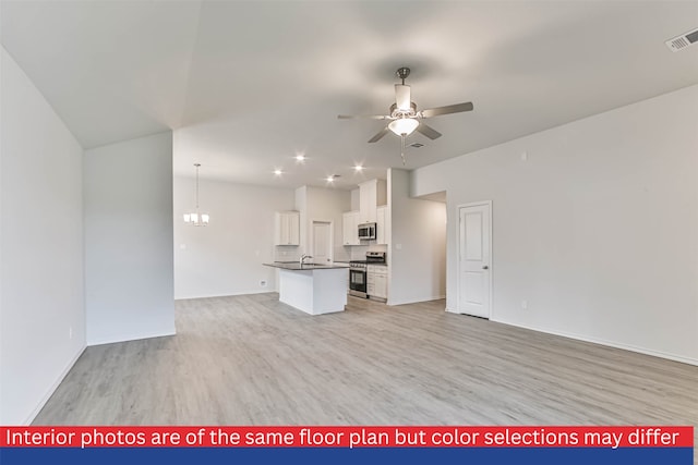 unfurnished living room featuring ceiling fan with notable chandelier, sink, and light wood-type flooring