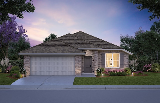 view of front of home with a lawn and a garage