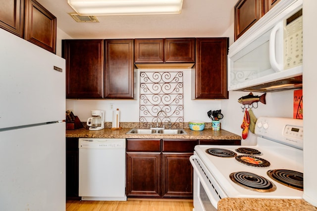 kitchen with white appliances, light hardwood / wood-style flooring, and sink