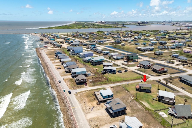 drone / aerial view featuring a beach view and a water view