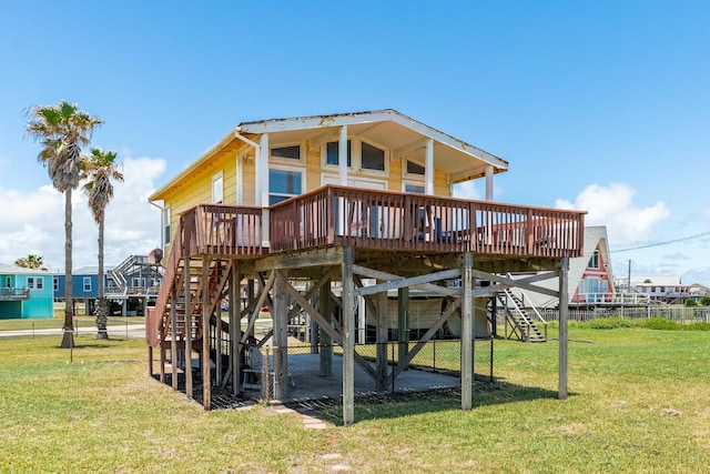 rear view of property featuring a yard and a deck