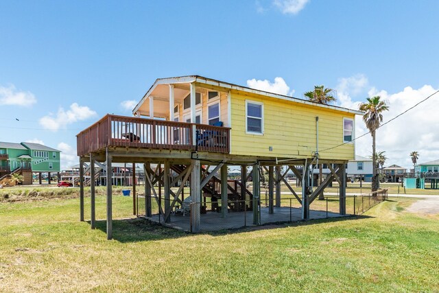 rear view of house featuring a yard