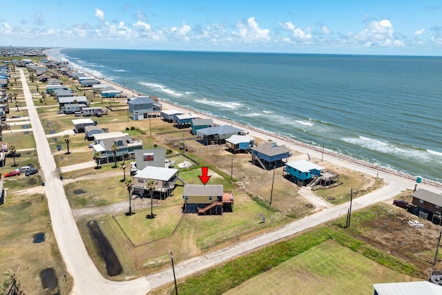 drone / aerial view featuring a beach view and a water view