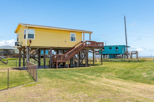 back of house featuring a lawn and central AC