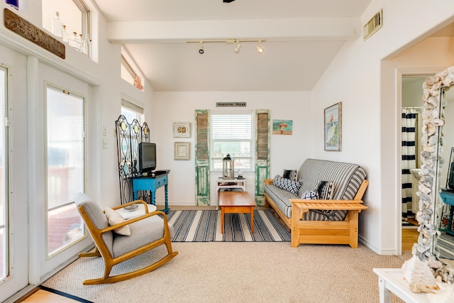 sitting room featuring lofted ceiling with beams, light carpet, and rail lighting