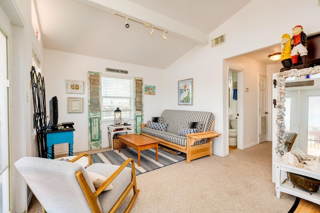 carpeted living room featuring track lighting and lofted ceiling with beams